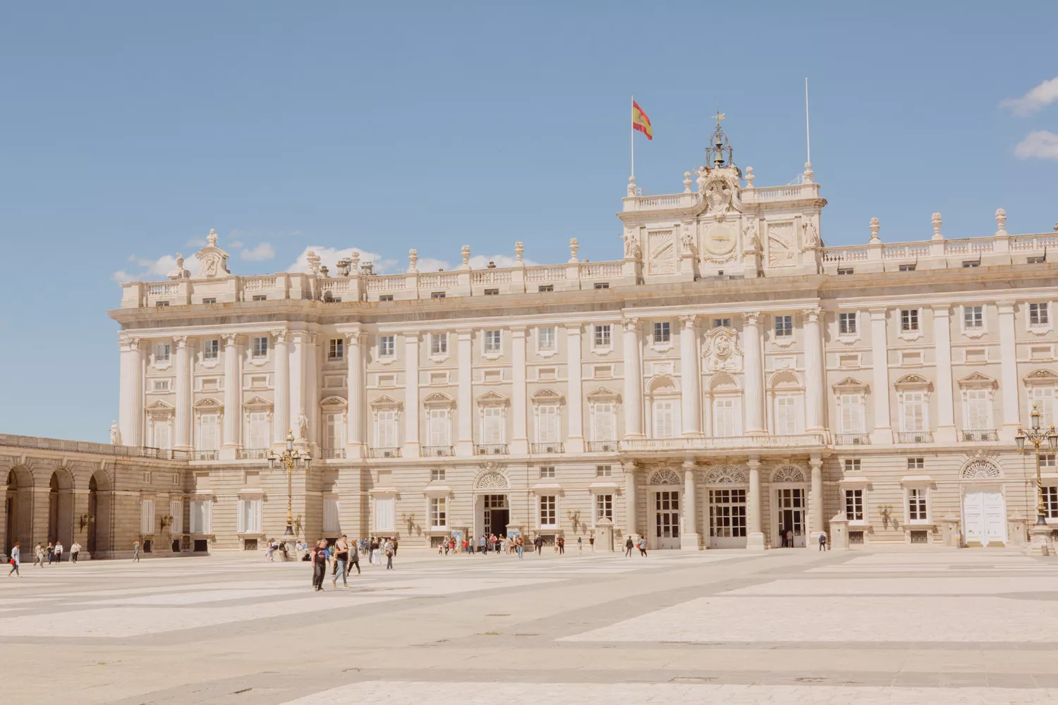 People walking outside of the royal palace in Madrid